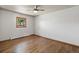 Comfortable bedroom features hardwood floors, a ceiling fan, and a sunny window at 741 S 6Th Ave, Brighton, CO 80601