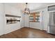 Cozy dining room showcasing a modern fireplace, hardwood floors, and natural light at 741 S 6Th Ave, Brighton, CO 80601