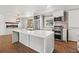 Modern kitchen featuring stainless steel appliances, a large island, and fireplace view at 741 S 6Th Ave, Brighton, CO 80601