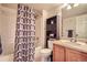 Functional bathroom with a shower-tub combo and a wooden vanity with storage at 22150 E Berry Pl, Aurora, CO 80015