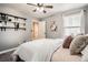 Comfortable bedroom with white bedding, gray walls, and stylish shelving and decor at 22150 E Berry Pl, Aurora, CO 80015