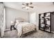 Comfortable bedroom with a metal frame bed, ceiling fan and shelving at 22150 E Berry Pl, Aurora, CO 80015