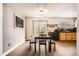 Well-lit dining room with a modern table set and bench seating, perfect for Gathering meals at 22150 E Berry Pl, Aurora, CO 80015