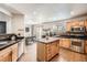 Spacious kitchen with wood cabinets, stainless steel appliances, and a kitchen island at 22150 E Berry Pl, Aurora, CO 80015