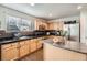 Well-lit kitchen featuring wood cabinets, stainless steel appliances, and black countertops at 22150 E Berry Pl, Aurora, CO 80015