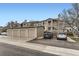 Townhome complex with multiple garages, well-maintained landscaping, and dedicated parking spaces at 8334 Pebble Creek Way # 201, Highlands Ranch, CO 80126