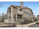 Two-story townhome with multiple balconies, a well-maintained lawn, and welcoming entryway at 8334 Pebble Creek Way # 201, Highlands Ranch, CO 80126