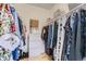 Organized walk-in closet with shelving, hanging rods, and ample storage space at 8334 Pebble Creek Way # 201, Highlands Ranch, CO 80126