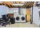 Basement with washer and dryer, desk, and exposed ceiling at 728 Poppywood Pl, Highlands Ranch, CO 80126