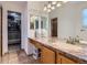 Bathroom with double sinks, vanity, and access to closet and bathroom at 728 Poppywood Pl, Highlands Ranch, CO 80126
