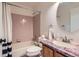 Bathroom with pink tile, shower-tub, sink, and granite countertop at 728 Poppywood Pl, Highlands Ranch, CO 80126