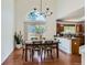 Bright dining room with a chandelier, large windows, and hardwood floors at 728 Poppywood Pl, Highlands Ranch, CO 80126