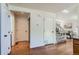 Bright entryway showcasing hardwood floors, multiple doors, and staircase to the upper level at 728 Poppywood Pl, Highlands Ranch, CO 80126
