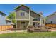 Exterior rear view with deck, grill, siding, and manicured lawn at 728 Poppywood Pl, Highlands Ranch, CO 80126