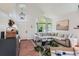 Bright living room featuring high ceilings, a large sectional sofa, and hardwood floors at 728 Poppywood Pl, Highlands Ranch, CO 80126