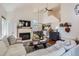 Bright living room with a fireplace, hardwood floors, an open staircase, and comfortable seating at 728 Poppywood Pl, Highlands Ranch, CO 80126