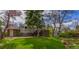 Well-manicured backyard with a lush lawn, mature trees, and a deck, perfect for outdoor living at 790 Mohawk Dr, Boulder, CO 80303