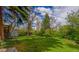 Spacious backyard featuring a grassy lawn, mature trees, and a storage shed at 790 Mohawk Dr, Boulder, CO 80303