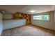 This basement features neutral walls and carpet, with a large window offering natural light at 790 Mohawk Dr, Boulder, CO 80303