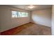 This bedroom features neutral walls and carpet, with a window offering natural light at 790 Mohawk Dr, Boulder, CO 80303