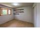 Cozy bedroom with neutral walls, carpet flooring, built-in shelving, and a large window at 790 Mohawk Dr, Boulder, CO 80303