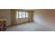 Bright living room featuring neutral walls, carpet, and a large window letting in natural light at 790 Mohawk Dr, Boulder, CO 80303