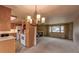 Open-concept kitchen and living room featuring neutral tones, a bright window, and wood cabinets at 790 Mohawk Dr, Boulder, CO 80303