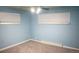 Light blue bedroom with neutral carpeting and ample closet space at 3667 N Monaco St, Denver, CO 80207