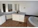 Main bathroom with soaking tub and double vanity at 7070 Henry St, Fort Lupton, CO 80621