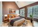 Bedroom offering a vaulted ceiling, two large windows, and modern decor at 836 S Vance St # D, Lakewood, CO 80226