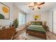 Cozy bedroom with a wooden bed frame, matching nightstands, and large windows at 836 S Vance St # D, Lakewood, CO 80226