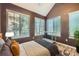 Bedroom features an angled ceiling, three large windows, and a plush rug at 836 S Vance St # D, Lakewood, CO 80226