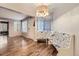 Open dining area with modern light fixture, wood floors, and a unique corner bench at 836 S Vance St # D, Lakewood, CO 80226