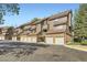 View of brown townhome community with brick accents and garage doors at 836 S Vance St # D, Lakewood, CO 80226