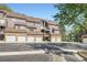 View of multi-story townhome complex with attached garages and well-maintained landscaping at 836 S Vance St # D, Lakewood, CO 80226