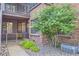 Brick condo exterior featuring a cozy porch, lush landscaping, and attractive architectural details at 836 S Vance St # D, Lakewood, CO 80226