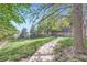 Scenic community grounds feature lush greenery, mature trees, and a paved walkway for leisurely strolls at 836 S Vance St # D, Lakewood, CO 80226