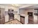 Updated kitchen with stainless appliances, granite counters, and direct sight lines to the living room fireplace at 836 S Vance St # D, Lakewood, CO 80226