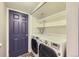 Efficient laundry closet equipped with washer, dryer, and shelving for organized storage solutions at 836 S Vance St # D, Lakewood, CO 80226