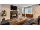 Living room showcasing a fireplace with a stone surround and built-in cabinets under bright windows at 836 S Vance St # D, Lakewood, CO 80226
