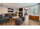 Comfortable living room featuring a fireplace, hardwood floors, and a gray sectional sofa at 836 S Vance St # D, Lakewood, CO 80226