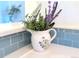 Charming flowers in a decorative pitcher add a touch of elegance to the tiled counter at 4760 S Wadsworth Blvd # F105, Littleton, CO 80123