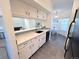 Well-equipped kitchen featuring white cabinetry, breakfast area, and sleek black appliances at 4760 S Wadsworth Blvd # F105, Littleton, CO 80123