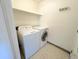 Convenient laundry room with washer, dryer, storage shelf, and tile flooring at 4760 S Wadsworth Blvd # F105, Littleton, CO 80123
