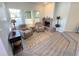 Comfortable living room featuring a brick fireplace, plush chairs, and natural light at 4760 S Wadsworth Blvd # F105, Littleton, CO 80123