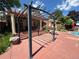 Community pool area with a pergola, patio, lounge chairs, and well-maintained landscaping at 4760 S Wadsworth Blvd # F105, Littleton, CO 80123