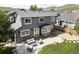 Aerial view of the backyard featuring a stone patio with seating and landscaped lawn at 6123 Dunraven Rd, Golden, CO 80403
