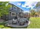 Backyard featuring a stone patio with outdoor furniture, a grill, and a well-manicured lawn at 6123 Dunraven Rd, Golden, CO 80403