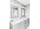 Bathroom featuring a double sink vanity with marble countertops, mirrors, and modern lighting at 6123 Dunraven Rd, Golden, CO 80403