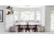 Bright dining area featuring a large table, built-in seating, and modern chandelier at 6123 Dunraven Rd, Golden, CO 80403